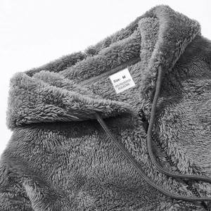 Detail view of the gray fleece hoodie showing size M label and soft fabric texture