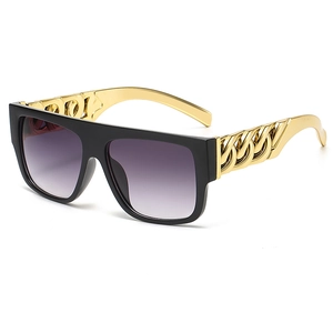 Black oversized square sunglasses featuring chunky gold metal chain temples and gradient lenses