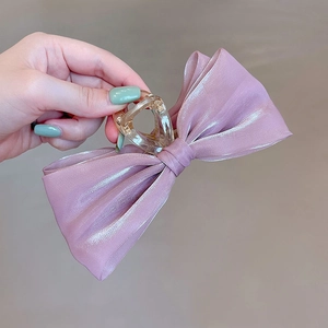 Detail of pink mesh fabric hair claw clip with elegant beaded pearls for voluminous hair