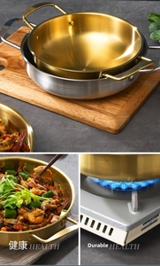 Polished stainless steel pans with durable riveted handles on a dark stone surface