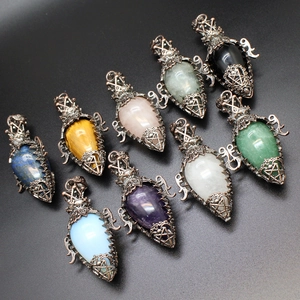 Detailed view of teardrop crystal pendants in vintage bronze filigree settings