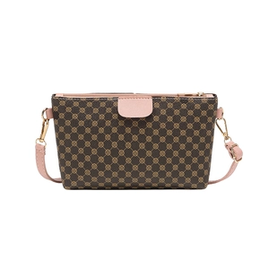 Chic brown clover print crossbody bag with pink flap and golden metal hardware