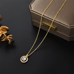 Close-up of gold circle pendant necklace with zircon crystals on a vintage jewelry box