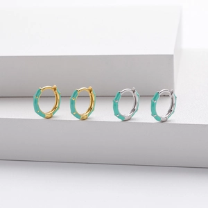 Detailed close-up of S925 sterling silver hoop earrings with mint green enamel coating