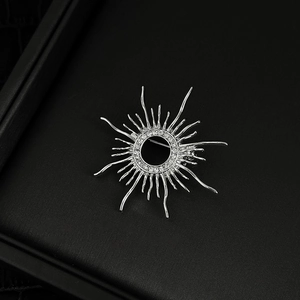 Silver sunburst brooch with 18k gold plating and micro-set cubic zirconia crystals