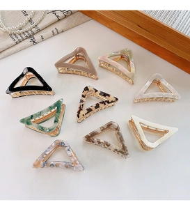 Macro shot of 9-pack hollow triangle hair clips in various patterns and colors