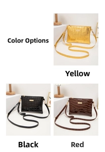 Three crocodile pattern envelope purses in yellow, black, and red with gold metal detail