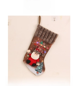 Detail of lighted Christmas stocking with Santa Claus doll and festive LED lights