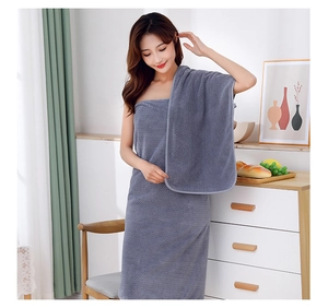 Gray coral fleece wearable bath towel wrap with waffle texture in a cozy home setting