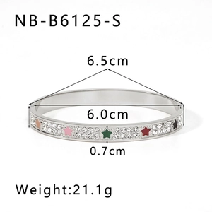 Detail view of silver stainless steel bangle showing diamond inlay and colorful star patterns
