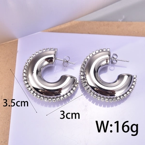 Macro detail of silver C-hoop earrings with zircon border showing dimensions and weight