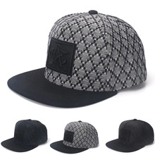 Detail of grey-black diamond plaid baseball cap with black brim and front logo patch