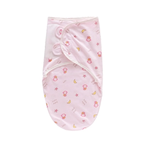 Detailed pattern of pink baby swaddle featuring monkeys, stars, and moon motifs