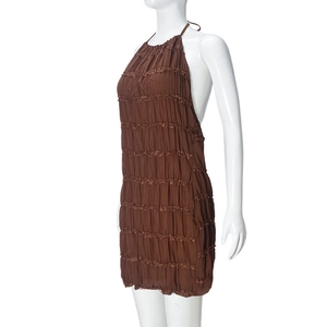 Close-up of brown halter backless dress with pleated layers and ruffled stitching details