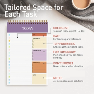 Flat lay of purple spiral daily planner with functional sections on a minimalist desk