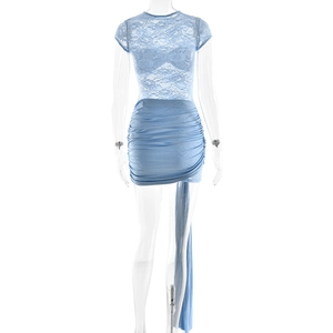 Detail of blue lace patchwork dress featuring elegant ruffles and long side streamers