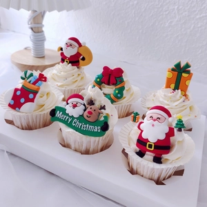Christmas cake toppers set featuring Santa, reindeer and tree on festive cupcakes
