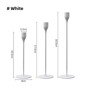 Three-piece white minimalist metal candle holders in varying heights for table decor
