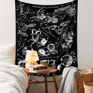 Detail view of a black constellation tapestry with white star charts on a bedroom wall