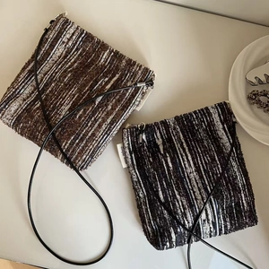 Macro shot of texture retro tweed crossbody mini bags with stripe pattern and strap