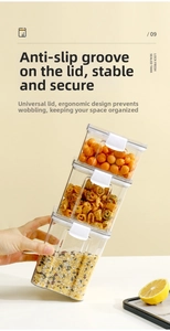 Detailed view of stacked clear plastic food storage jars with white locking lids