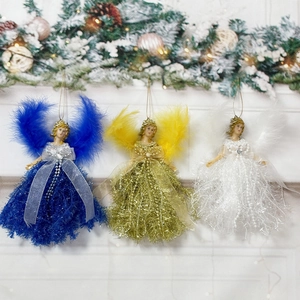 Three Christmas angel pendants in blue, gold and white hanging on a festive pine wreath