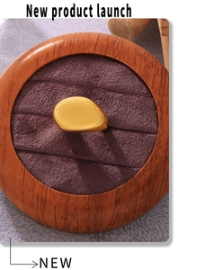 Close-up of irregular organic gold ring displayed in a minimalist wooden jewelry box