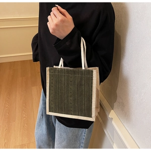 Linen tote bag with olive green and beige texture held by a model for daily use