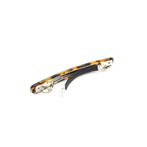 Slim tortoiseshell resin hair clip with classic spring mechanism on white background
