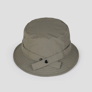 Detail of greyish-green nylon sun hat with utility straps and reinforced stitching