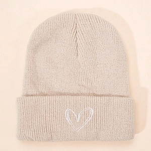 Classic cream knitted beanie featuring minimalist heart embroidery in a soft winter style