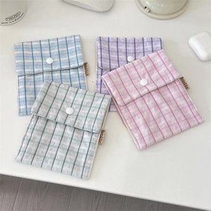 Detailed view of four colorful floral fabric pouches with snap button closure and side labels