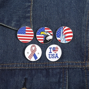 Detailed close-up of 5-piece American flag enamel pins on dark denim background