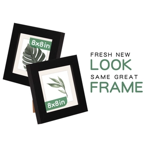 Detail of two black 8x8 inch square wooden photo frames with white matting and plant art