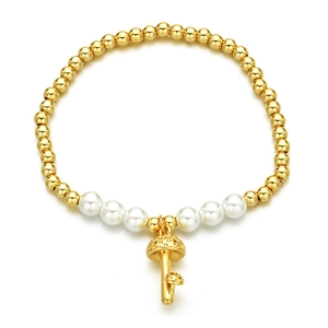 Beaded bracelet with golden copper beads, white pearls and a cute mushroom charm