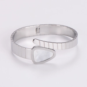 Detailed close-up of silver Tubogas snake bracelet featuring a white triangular shell inlay