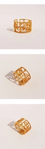 Macro view of gold vintage open ring with hollow carvings and zircon stone detailing