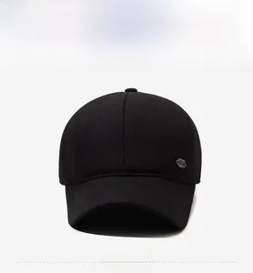 Detail of black men's winter baseball cap with metal logo on high-quality wool fabric