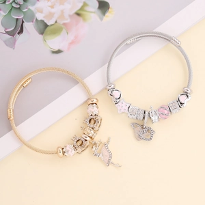 Sparkling DIY charm bracelet with pink crown and ballet dancer pendants in gold and silver