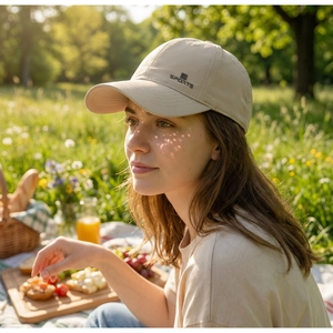Beige quick-dry sports cap featuring a stylish SPORTS logo in a sunny outdoor setting