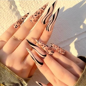 Long stiletto press-on nails with matte leopard print and black swirl patterns for women