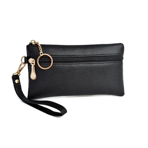 Close-up of black lychee texture leather pouch with gold zipper and wrist strap