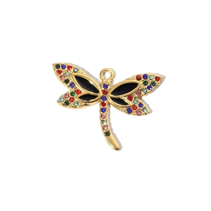 Macro detail of a dragonfly pendant with multi-colored gemstones in a gold-plated base