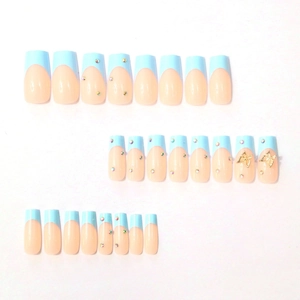 Blue French press-on nails set with 3D gold butterflies and colorful rhinestones