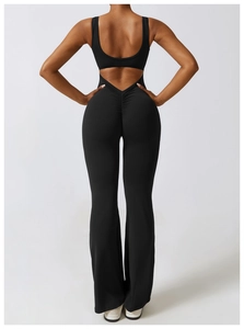 Detail view of black yoga jumpsuit featuring back cutout and flattering ruched butt detail
