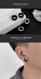 Detailed close-up of black and silver titanium steel hoop earrings on a male model