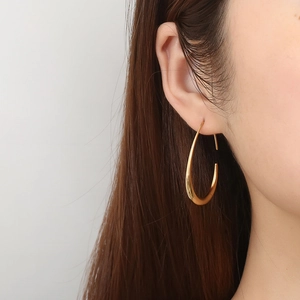 Fashionable gold egg-shaped drop earrings for women with sleek metallic finish