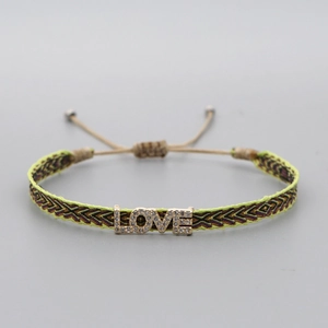 Detail of woven boho bracelet with LOVE metal charm and sparkling zirconia accents
