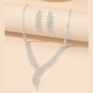 Close-up of elegant silver-toned rhinestone necklace and matching earrings set