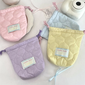 Quilted drawstring camera pouch in pastel colors for protection and outdoor storage